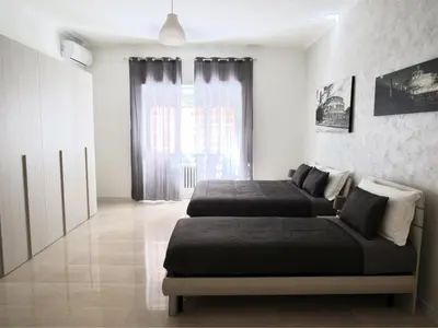 a bedroom with two beds and a window at Roema Guest House in Rome
