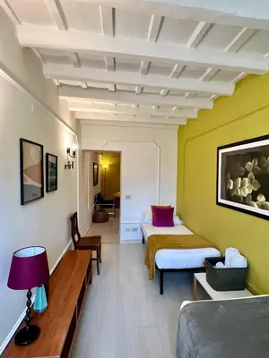 a hotel room with two beds and a couch at Charming Navona in Rome
