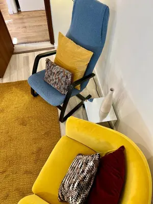 a living room with a yellow couch and a chair at Charming Navona in Rome
