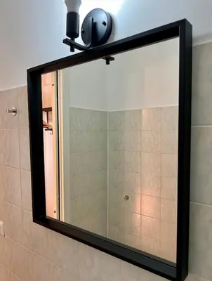 a large mirror on a wall in a bathroom at Charming Navona in Rome
