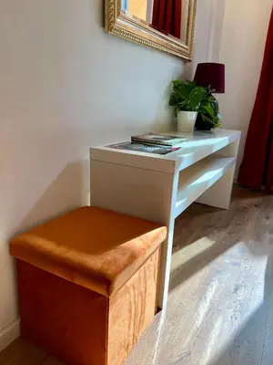 a desk with a plant and a stool in a room at Charming Navona in Rome