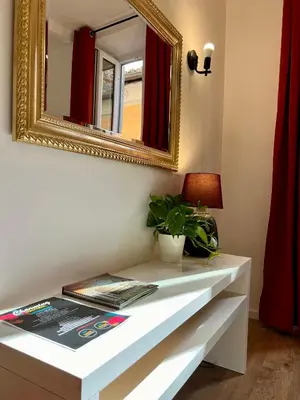 a white table with a mirror and a plant on it at Charming Navona in Rome