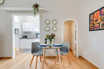 a kitchen and dining room with a table and chairs at Rome as you feel - Grotta Pinta apartments in Rome