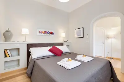 a bedroom with a bed with two towels on it at Rome as you feel - Grotta Pinta apartments in Rome