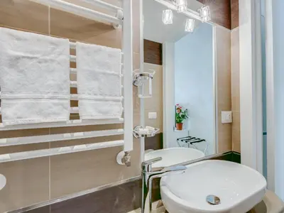 a bathroom with a white sink and a mirror at Penta Luxury House in Rome