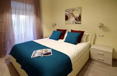 a bedroom with a bed with a book on it at CdR Guest House in Rome