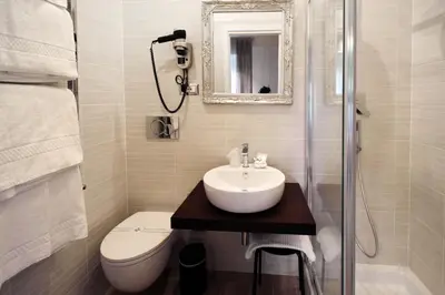a bathroom with a sink and a toilet and a mirror at CdR Guest House in Rome