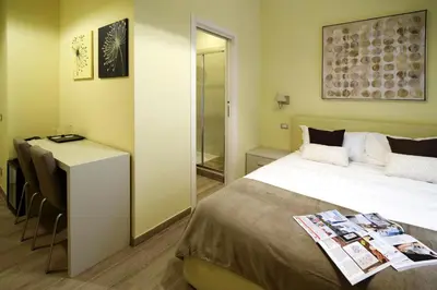 a bedroom with a bed and a table and a desk at CdR Guest House in Rome