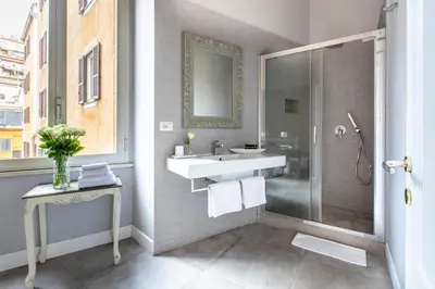 a bathroom with a sink and a shower at Spagna Art & Suites - CA Domus Collection in Rome