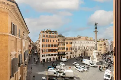 a city street with cars parked in a parking lot at Spagna Art & Suites - CA Domus Collection in Rome