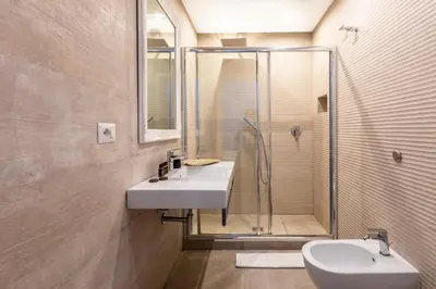 a bathroom with a sink and a shower at Spagna Art & Suites - CA Domus Collection in Rome