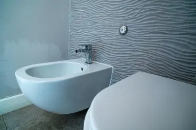 a bathroom with a white toilet and a sink at Spagna Art & Suites - CA Domus Collection in Rome