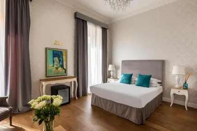 a bedroom with a large bed and a fireplace at Spagna Art & Suites - CA Domus Collection in Rome