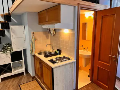 a small kitchen with a sink and a stove at MoonLight Suite in Rome