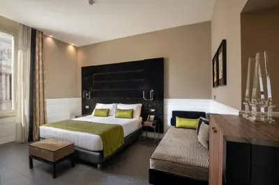 a hotel room with a bed and a desk at The Glam in Rome