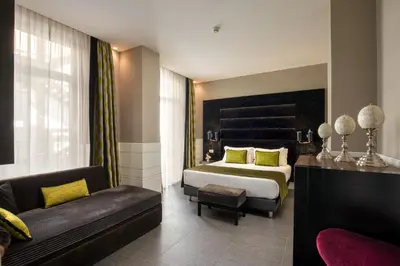 a hotel room with a bed and a couch at The Glam in Rome