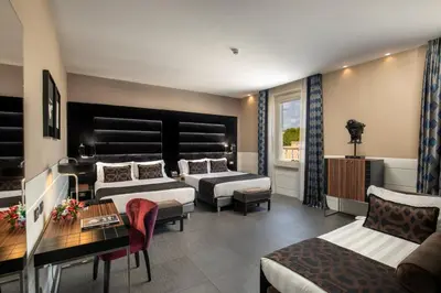 a hotel room with two beds and a couch at The Glam in Rome