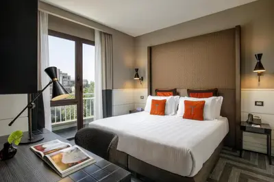 a hotel room with a large bed and a window at The Tribune, part of JdV by Hyatt in Rome