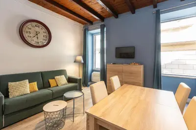 a living room with a green couch and a table at Piazza Navona Lovely Apartment in Rome