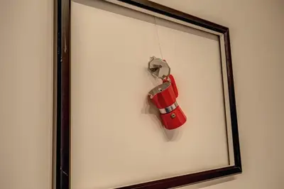 a red toy car hanging in a framed picture at La Casa Di Amy in Rome