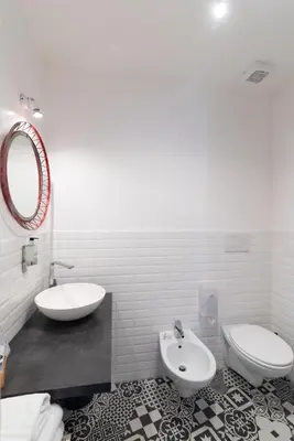 a white bathroom with a sink and a toilet at La Casa Di Amy in Rome