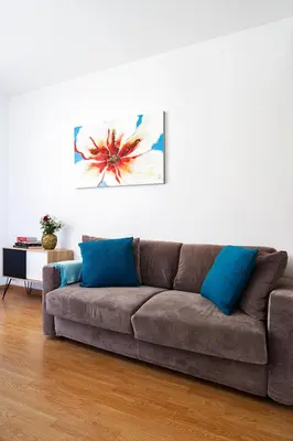 a brown couch in a living room with blue pillows at Ciao Bella Stella in Rome
