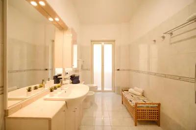a white bathroom with a sink and a toilet at Midnight in Vatican in Rome