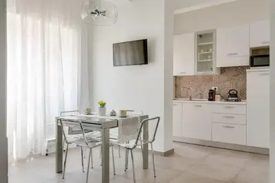 a kitchen with a table and chairs in a room at Franca's Home in Rome