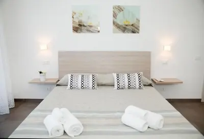 a bedroom with a large bed with two white towels at Franca's Home in Rome