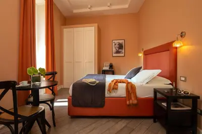 a hotel room with a bed and a table at My Trevi Charming & Luxury Rooms in Rome