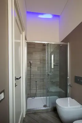 a bathroom with a shower with a toilet and a sink at My Trevi Charming & Luxury Rooms in Rome