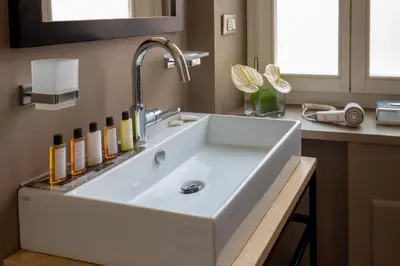 a bathroom with a white sink and a counter at My Trevi Charming & Luxury Rooms in Rome