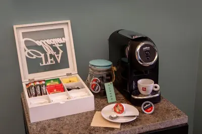 a counter top with a coffee maker and a coffee mug at My Trevi Charming & Luxury Rooms in Rome