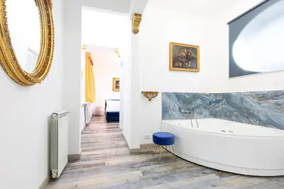 a bathroom with a tub and a mirror at Il Monastero Collection in Rome