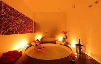 a woman laying in a bath tub in a bathroom at Sant'Angelo Exclusive Spacious Art in Rome