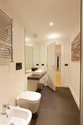 a bathroom with a white toilet and a sink at Sant'Angelo Exclusive Spacious Art in Rome