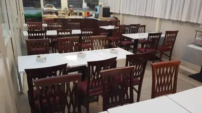a dining room with white tables and red chairs at Hotel Best Roma in Rome