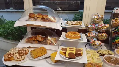 a display of different types of cakes and pastries at Hotel Best Roma in Rome
