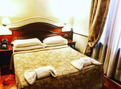 a bedroom with a bed with two towels on it at Hotel Best Roma in Rome