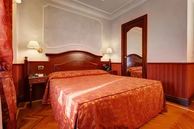 a hotel room with a bed and a mirror at Hotel Best Roma in Rome