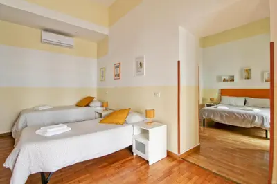a bedroom with two beds and a sink at Roman House in Rome