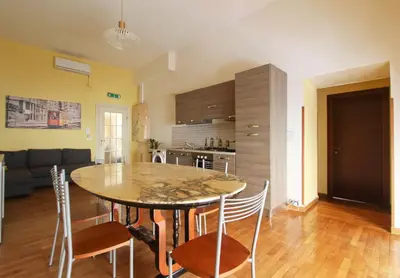 a kitchen and dining room with a table and chairs at Roman House in Rome
