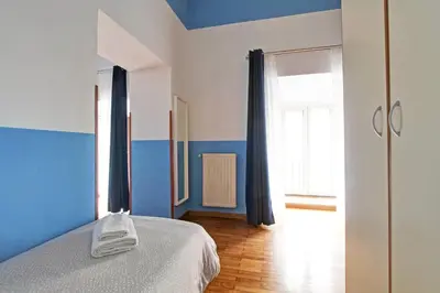 a bedroom with blue and white walls and a bed at Roman House in Rome