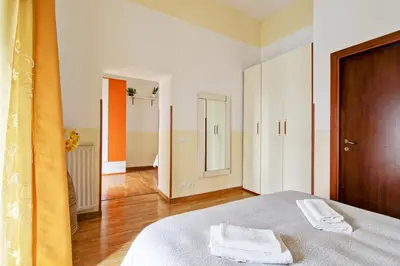 a bedroom with a bed with two towels on it at Roman House in Rome