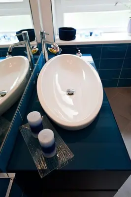 a bathroom with a white sink and two stools at Residenza San Pio V in Rome