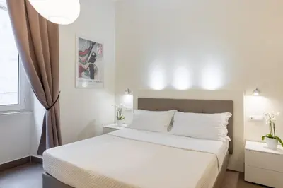 a bedroom with a white bed and a window at Maison Trevi in Rome