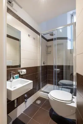 a bathroom with a toilet and a sink and a shower at Maison Trevi in Rome