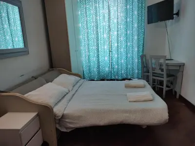 a bedroom with a bed with two towels on it at Happy Rome in Rome