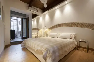 a bedroom with a large bed and a large mirror at River View Apartment in Rome