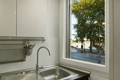 a kitchen sink with a window above it at River View Apartment in Rome